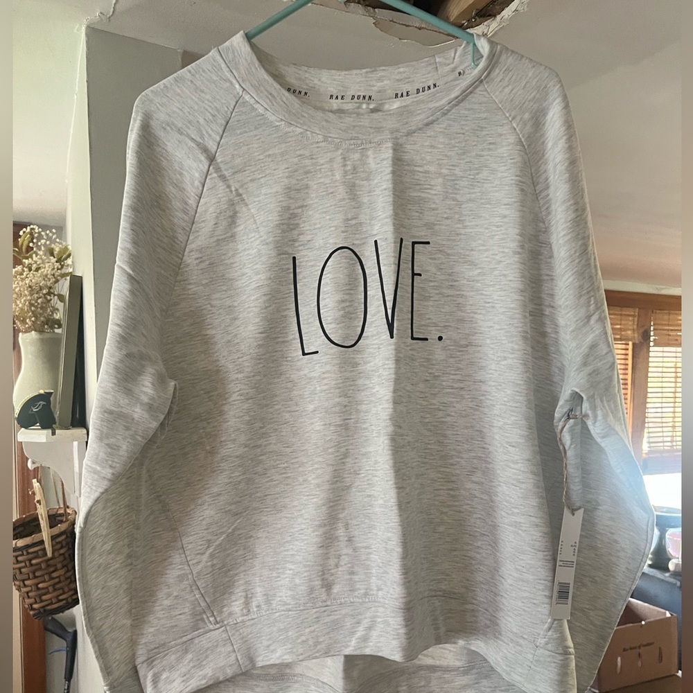 light gray Rae Dunn "LOVE" sweatshirt featuring a crew neck and relaxed fit